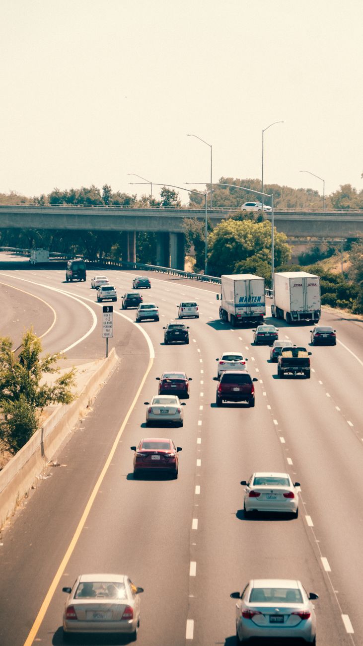 busy highway scene with cars and trucks